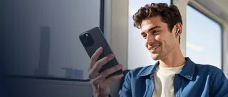 Ein Mann, der Musik über sein Handy hört.